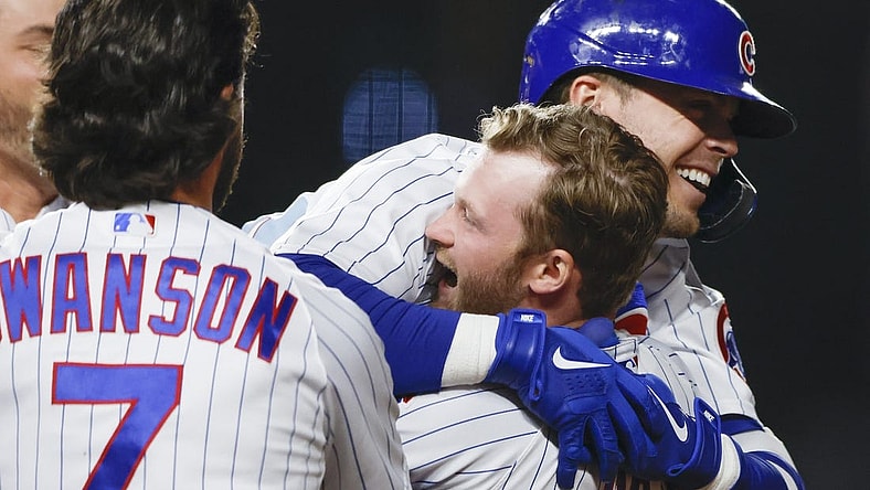 Apr 10, 2023; Chicago, Illinois, USA; Chicago Cubs second baseman Nico Hoerner (2) celebrates with teammates after hitting game winning single against the Seattle Mariners during the 10th inning at Wrigley Field. Mandatory Credit: Kamil Krzaczynski-USA TODAY Sports