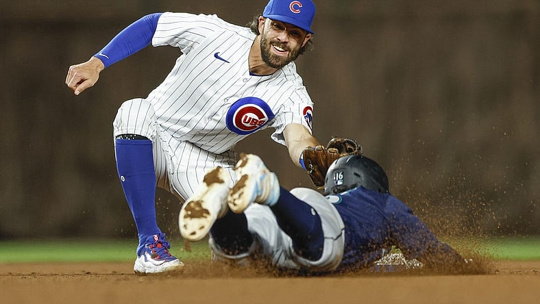 Apr 10, 2023; Chicago, Illinois, USA; Chicago Cubs shortstop Dansby Swanson (7) tags out Seattle Mariners second baseman Kolten Wong (16) as he tries to steal second base during the ninth inning at Wrigley Field. Mandatory Credit: Kamil Krzaczynski-USA TODAY Sports
