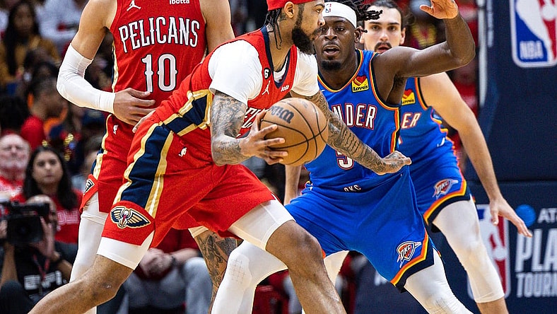 Apr 12, 2023; New Orleans, Louisiana, USA; New Orleans Pelicans forward Brandon Ingram (14) dribbles against Oklahoma City Thunder guard Luguentz Dort (5) during the first half at Smoothie King Center. Mandatory Credit: Stephen Lew-USA TODAY Sports