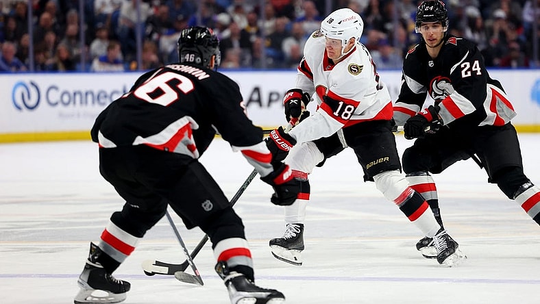 Apr 13, 2023; Buffalo, New York, USA;  Ottawa Senators left wing Tim St  tzle (18) skates with the puck as Buffalo Sabres defenseman Ilya Lyubushkin (46) defends during the first period at KeyBank Center. Mandatory Credit: Timothy T. Ludwig-USA TODAY Sports