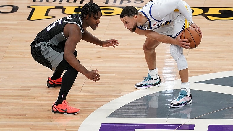 Apr 15, 2023; Sacramento, California, USA; Golden State Warriors guard Stephen Curry (30) holds onto the ball next to Sacramento Kings guard Davion Mitchell (15) in the second quarter during game one of the 2023 NBA playoffs at the Golden 1 Center. Mandatory Credit: Cary Edmondson-USA TODAY Sports