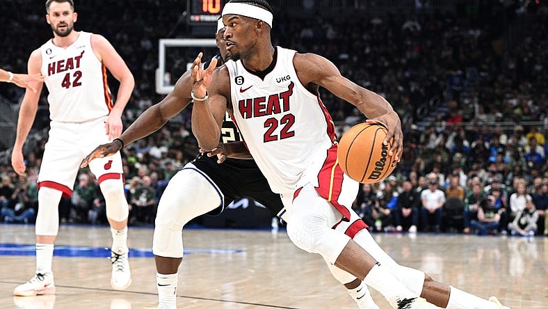 Apr 16, 2023; Milwaukee, Wisconsin, USA; Miami Heat forward Jimmy Butler (22) drives to the basket against Milwaukee Bucks guard Jrue Holiday (21) in the first half during game one of the 2023 NBA Playoffs at Fiserv Forum. Mandatory Credit: Michael McLoone-USA TODAY Sports