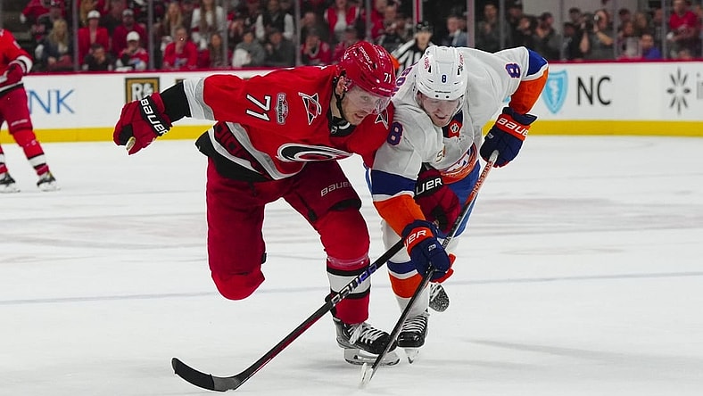Apr 19, 2023; Raleigh, North Carolina, USA; Carolina Hurricanes right wing Jesper Fast (71) and New York Islanders defenseman Noah Dobson (8) chase after the puck during the third period in game two of the first round of the 2023 Stanley Cup Playoffs at PNC Arena. Mandatory Credit: James Guillory-USA TODAY Sports