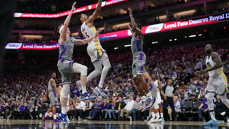 Apr 26, 2023; Sacramento, California, USA; Golden State Warriors guard Jordan Poole (3) makes a basket between Sacramento Kings guard Kevin Huerter (9) and guard De'Aaron Fox (5) in the third quarter during game five of the 2023 NBA playoffs at the Golden 1 Center. Mandatory Credit: Cary Edmondson-USA TODAY Sports