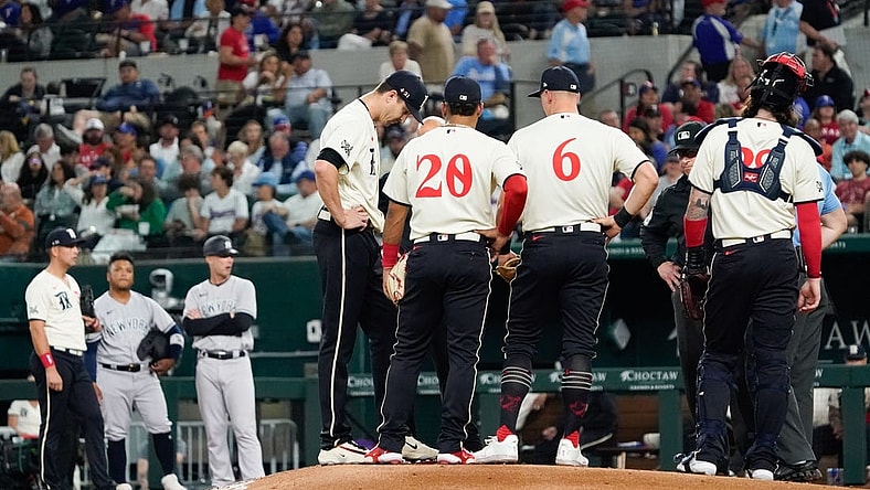 Apr 28, 2023; Arlington, Texas, USA; Texas Rangers starting pitcher Jacob deGrom (48) is visited on the mound by teammates and pitching coach pitching coach Mike Maddux (31) before leaving the game in the fourth inning against the New York Yankees at Globe Life Field. Mandatory Credit: Raymond Carlin III-USA TODAY Sports