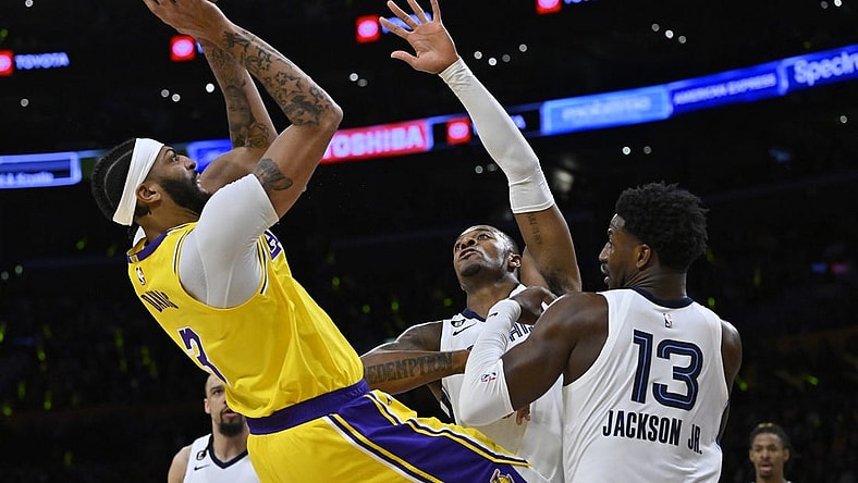Apr 28, 2023; Los Angeles, California, USA;Los Angeles Lakers forward Anthony Davis (3) is defended by Memphis Grizzlies forward Xavier Tillman (2) and forward Jaren Jackson Jr. (13) as he goes up for a shot in the first quarter of game six of the 2023 NBA playoffs at Crypto.com Arena. Mandatory Credit: Jayne Kamin-Oncea-USA TODAY Sports