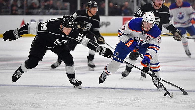 Apr 29, 2023; Los Angeles, California, USA; Edmonton Oilers center Connor McDavid (97) moves the puck against Los Angeles Kings center Rasmus Kupari (89) during the first period in game six of the first round of the 2023 Stanley Cup Playoffs at Crypto.com Arena. Mandatory Credit: Gary A. Vasquez-USA TODAY Sports