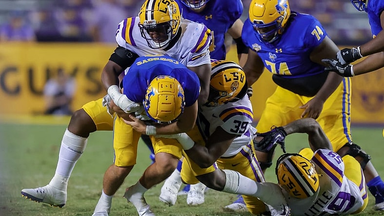 Sep 11, 2021; Baton Rouge, Louisiana, USA;  LSU Tigers defensive lineman Maason Smith (0) sacks McNeese State Cowboys quarterback Cody Orgeron (8) during the second half at Tiger Stadium. Mandatory Credit: Stephen Lew-USA TODAY Sports