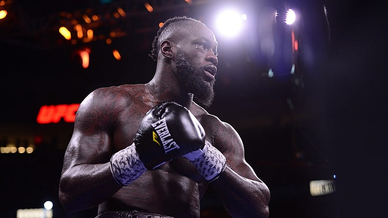 Oct 9, 2021; Las Vegas, Nevada, USA; Deontay Wilder (red/black trunks) and Tyson Fury (black/gold trunks) box during their WBC/Lineal heavyweight championship boxing match at T-Mobile Arena. Mandatory Credit: Joe Camporeale-USA TODAY Sports