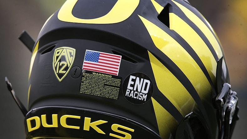 An "End racism" sticker joins the American Flag on the helmets of Oregon players Saturday Oct. 30, 2021.

Eug 103021 Uo Cofb03