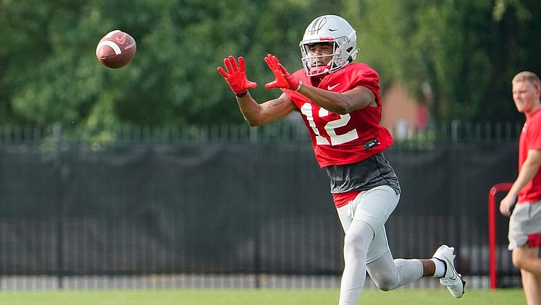 Aug 4, 2022; Columbus, OH, USA;  Ohio State Buckeyes wide receiver Caleb Burton (12) catches a pass during the first fall football practice at the Woody Hayes Athletic Center. Mandatory Credit: Adam Cairns-The Columbus Dispatch

Ohio State Football First Practice