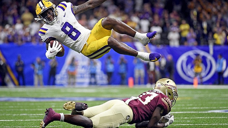 Sep 4, 2022; New Orleans, Louisiana, USA; Louisiana State Tigers wide receiver Malik Nabers (8) goes airborne as he is tackled by Florida State Seminoles defensive back Omarion Cooper (13) during the second half at Caesars Superdome. Mandatory Credit: Melina Myers-USA TODAY Sports