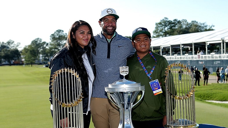 Nov 13, 2022; Houston, Texas, USA; Tony Finau poses for a photo with his family with the championship trophy and both Houston Astros world championship trophies after winning the Cadence Bank Houston Open golf tournament. Mandatory Credit: Erik Williams-USA TODAY Sports