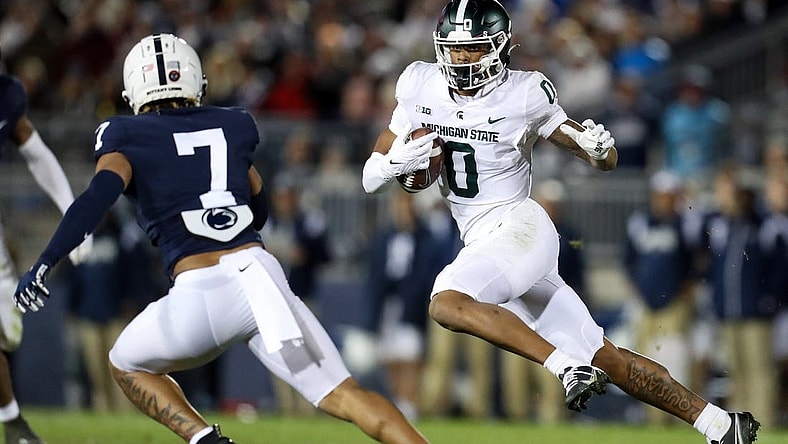 Nov 26, 2022; University Park, Pennsylvania, USA; Michigan State Spartans wide receiver Keon Coleman (0) runs the ball against Penn State Nittany Lions safety Jaylen Reed (7) during the fourth quarter at Beaver Stadium. Penn State won 35-16. Mandatory Credit: Matthew OHaren-USA TODAY Sports
