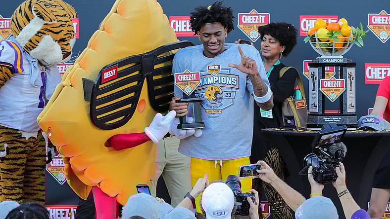 Jan 2, 2023; Orlando, FL, USA; LSU Tigers wide receiver Malik Nabers (8) is presented with most valuable player trophy by Cheez-it mascot after the game against the Purdue Boilermakers at Camping World Stadium. Mandatory Credit: Mike Watters-USA TODAY Sports