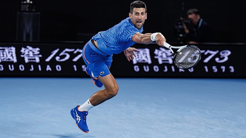 Jan 29, 2023; Melbourne, Victoria, Australia; Novak Djokovic of Serbia hits a shot against Stefanos Tsitsipas of Greece at the men's final on day fourteen of the 2023 Australian Open tennis tournament at Melbourne Park. Mandatory Credit: Mike Frey-USA TODAY Sports