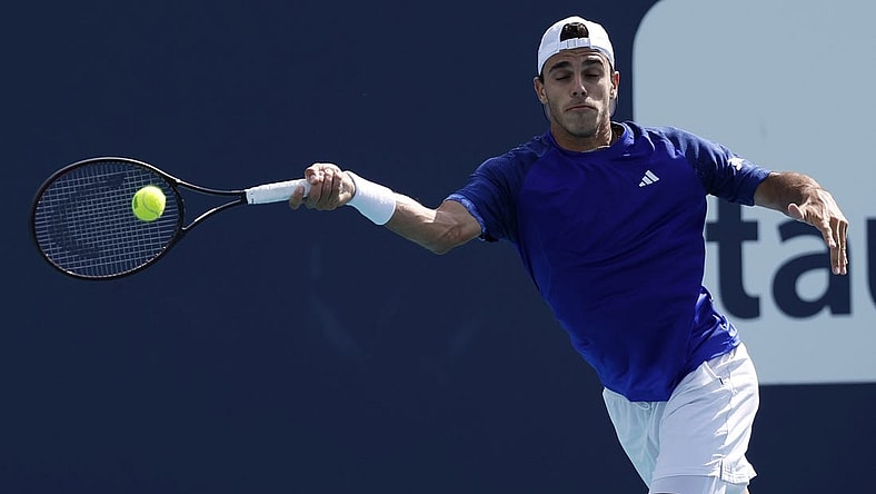 Mar 30, 2023; Miami, Florida, US; Francisco Cerundolo (ARG) hits a forehand against Karen Khachanov (not pictured) in a men's singles quarterfinal on day eleven of the Miami Open at Hard Rock Stadium. Mandatory Credit: Geoff Burke-USA TODAY Sports