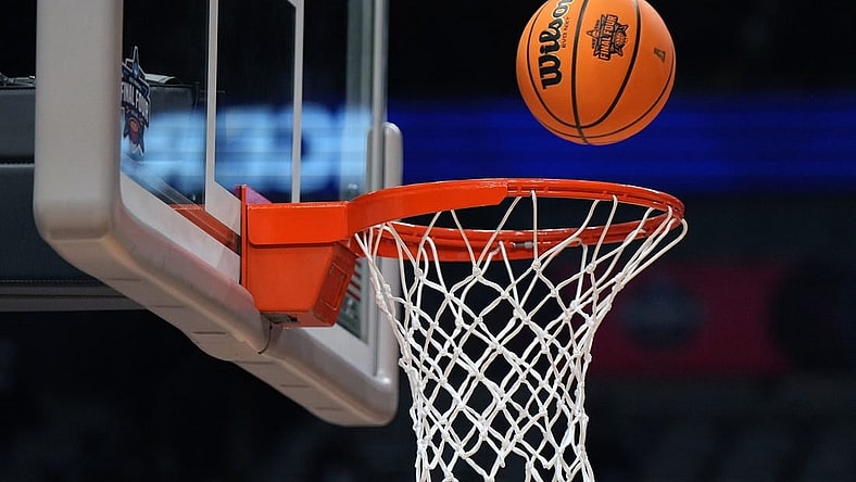 Mar 30, 2023; Dallas, TX, USA;  A Wilson EVO NXT basketball with the NCAA Women's Final Four logo goes through the rim and net at American Airlines Center. Mandatory Credit: Kirby Lee-USA TODAY Sports