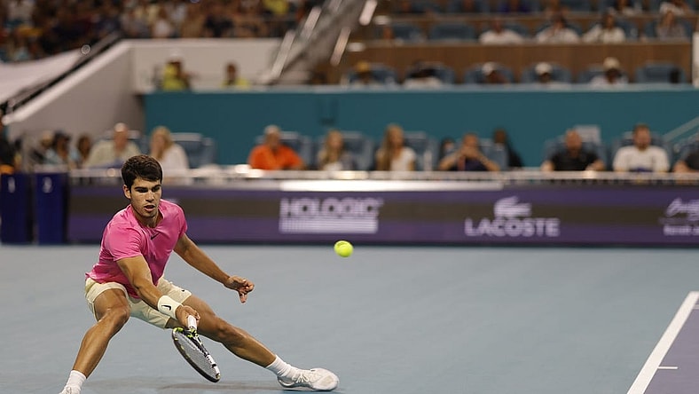 Mar 31, 2023; Miami, Florida, US; Carlos Alcaraz (ESP) reaches for a forehand against Jannik Sinner (ITA) (not pictured) in a men's singles semifinal on day twelve on the Miami Open at Hard Rock Stadium. Mandatory Credit: Geoff Burke-USA TODAY Sports