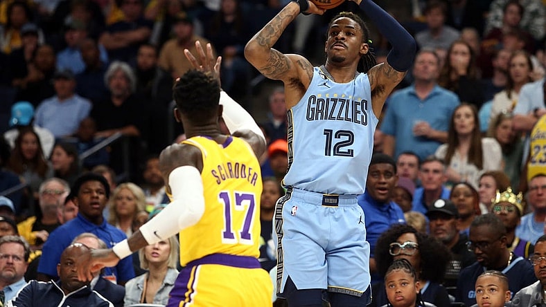 Apr 26, 2023; Memphis, Tennessee, USA; Memphis Grizzlies guard Ja Morant (12) shoots a three point shot as Los Angeles Lakers guard Dennis Schroder (17) defends during the second half of game five of the 2023 NBA playoffs at FedExForum. Mandatory Credit: Petre Thomas-USA TODAY Sports