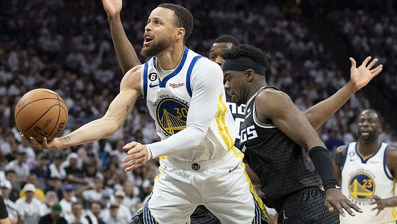 April 30, 2023; Sacramento, California, USA; Golden State Warriors guard Stephen Curry (30) shoots the basketball against Sacramento Kings forward Harrison Barnes (40) and guard Terence Davis (3) during the third quarter in game seven of the 2023 NBA playoffs first round at Golden 1 Center. Mandatory Credit: Kyle Terada-USA TODAY Sports