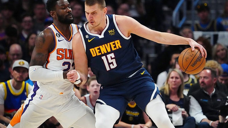 May 1, 2023; Denver, Colorado, USA; Denver Nuggets center Nikola Jokic (15) drives at Phoenix Suns center Deandre Ayton (22) in the first quarter during game two of the 2023 NBA playoffs at Ball Arena. Mandatory Credit: Ron Chenoy-USA TODAY Sports