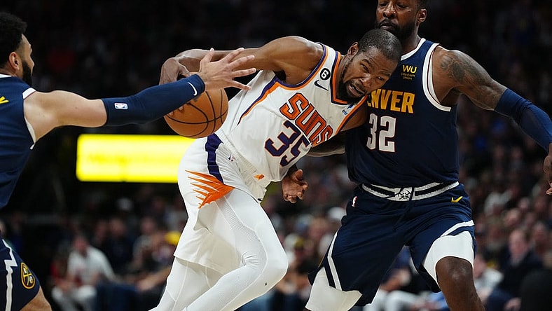 May 1, 2023; Denver, Colorado, USA; Phoenix Suns forward Kevin Durant (35) drives at Denver Nuggets forward Jeff Green (32) in the first half during game two of the 2023 NBA playoffs at Ball Arena. Mandatory Credit: Ron Chenoy-USA TODAY Sports