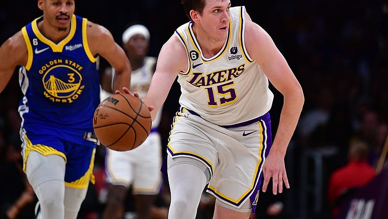 May 6, 2023; Los Angeles, California, USA; Los Angeles Lakers guard Austin Reaves (15) moves the ball ahead of Golden State Warriors guard Jordan Poole (3) during the first half in game three of the 2023 NBA playoffs at Crypto.com Arena. Mandatory Credit: Gary A. Vasquez-USA TODAY Sports