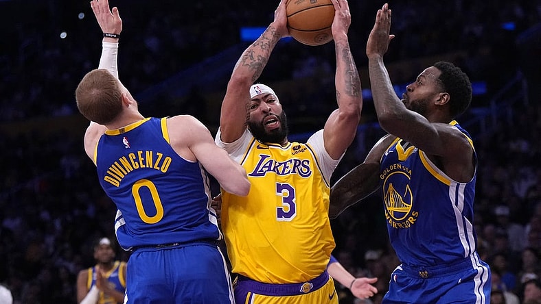 May 8, 2023; Los Angeles, California, USA; Los Angeles Lakers forward Anthony Davis (3) is defended by Golden State Warriors guard Donte DiVincenzo (0) and forward JaMychal Green (1) in the first half during game four of the 2023 NBA playoffs at Crypto.com Arena. Mandatory Credit: Kirby Lee-USA TODAY Sports