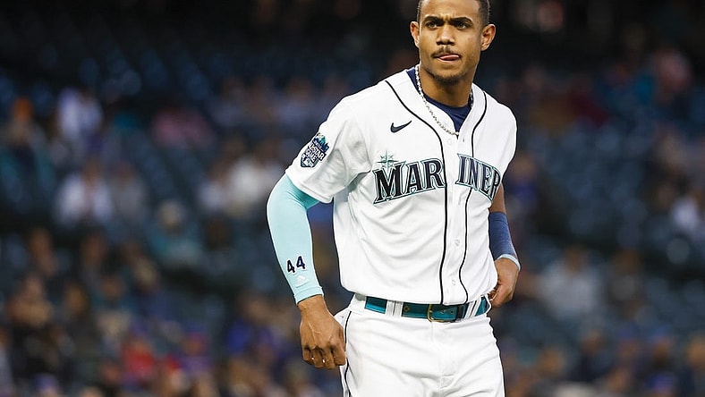 May 9, 2023; Seattle, Washington, USA; Seattle Mariners center fielder Julio Rodriguez (44) waits for his glove and hat from a teammate after striking out to end the seventh inning against the Texas Rangers at T-Mobile Park. Mandatory Credit: Joe Nicholson-USA TODAY Sports