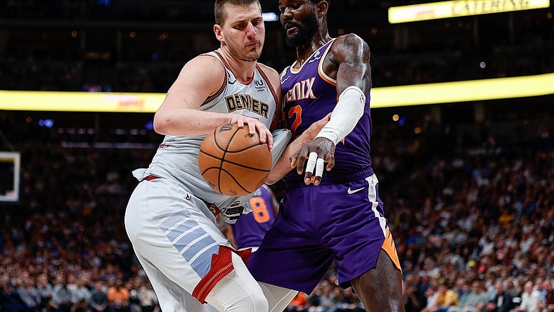 May 9, 2023; Denver, Colorado, USA; Denver Nuggets center Nikola Jokic (15) controls the ball as Phoenix Suns center Deandre Ayton (22) defends in the fourth quarter during game five of the 2023 NBA playoffs at Ball Arena. Mandatory Credit: Isaiah J. Downing-USA TODAY Sports