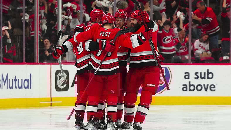 May 11, 2023; Raleigh, North Carolina, USA; Carolina Hurricanes center Jesperi Kotkaniemi (82) is congratulated by right wing Jesper Fast (71) defenseman Brent Burns (8) and defenseman Jaccob Slavin (74) after his goal against the New Jersey Devils during the second period in game five of the second round of the 2023 Stanley Cup Playoffs at PNC Arena. Mandatory Credit: James Guillory-USA TODAY Sports