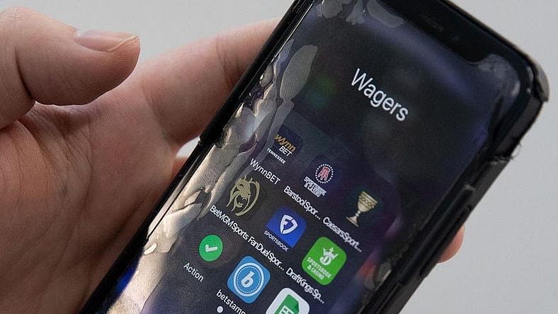 Sports betting apps are shown on a smart phone.