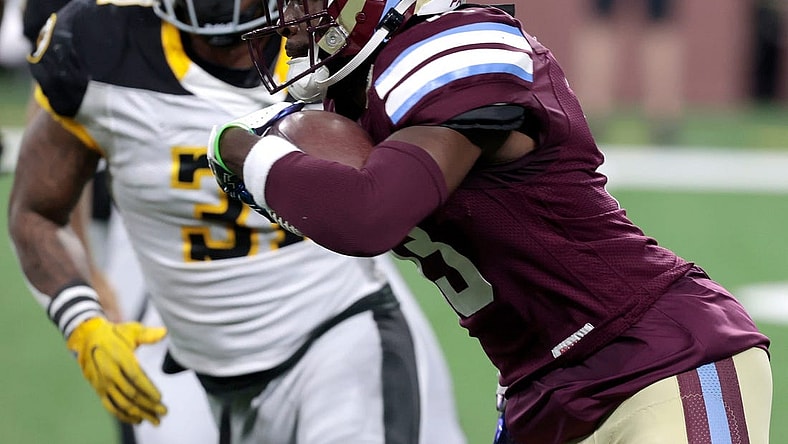 Michigan Panthers wide receiver Ishmael Hyman runs for extra yards as Pittsburgh Maulers defender Kyahva Tezino closes in to stop him during the game at Ford Field in Detroit on Saturday, May 13, 2023. The Maulers beat the Panthers, 23-7.