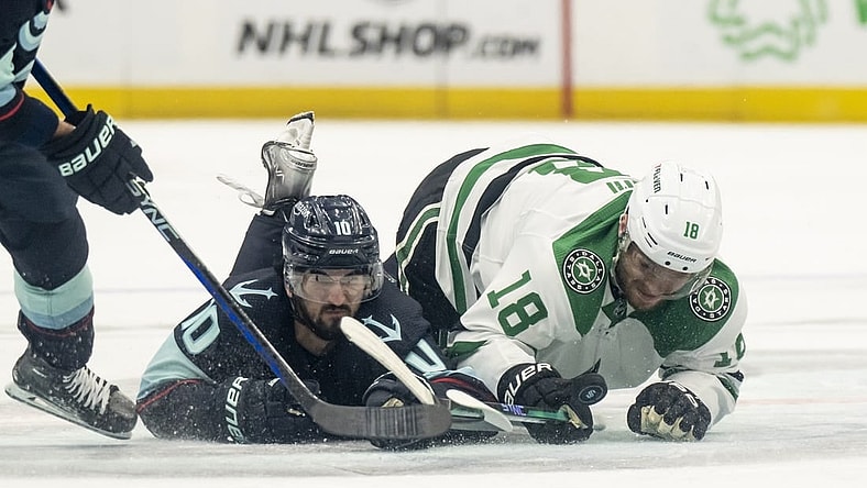 May 13, 2023; Seattle, Washington, USA; Seattle Kraken forward Matty Beniers (10) and Dallas Stars forward Max Domi (18) dive for a loose puck during the second period in game six of the second round of the 2023 Stanley Cup Playoffs at Climate Pledge Arena. Mandatory Credit: Stephen Brashear-USA TODAY Sports