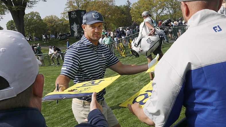 Bryson DeChambeau signs autographs for fans as he leaves the practice range before staring his practice round at the PGA Championship at Oak Hill Country Club Monday, May 15, 2023.