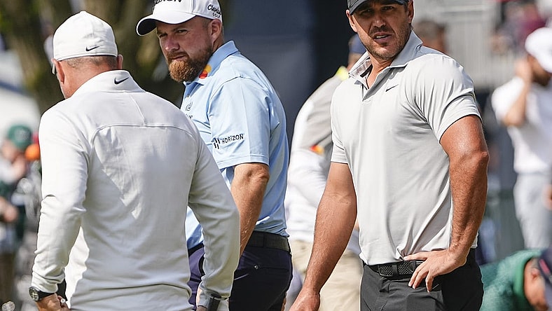 May 15, 2023; Rochester, New York, USA; Brooks Koepka (right) and Marc Leishman stand on the putting green during a practice round of the PGA Championship golf tournament at Oak Hill Country Club. Mandatory Credit: Adam Cairns-USA TODAY Sports