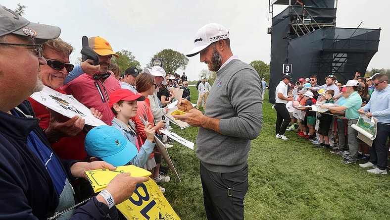 LIV Golf star Dustin Johnson stops to sign autographs after a practice round at the PGA Championship on Tuesday, May 16, 2023.