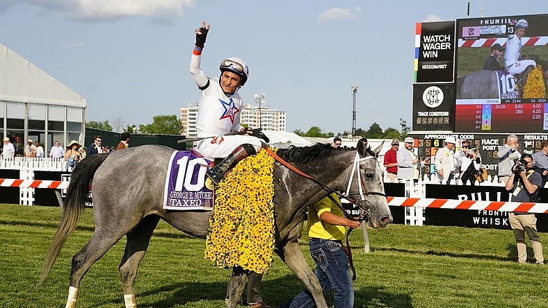 May 19, 2023; Baltimore, Maryland, USA; Taxed with Rafael Bejarno up (10) waves to the crowd after winning the Black Eyed Susan at Pimlico Race Course. Mandatory Credit: Gregory Fisher-USA TODAY Sports