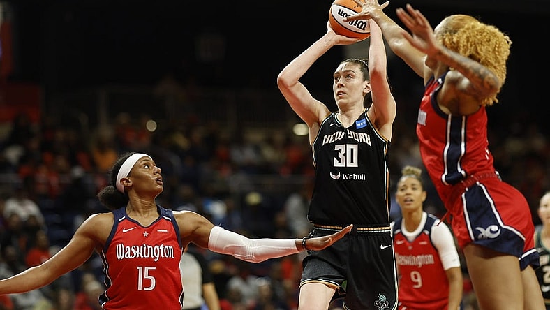 May 19, 2023; Washington, District of Columbia, USA; New York Liberty forward Breanna Stewart (30) shoots the ball as Washington Mystics guard Brittney Sykes (15) and Mystics center Shakira Austin (0) defend in the second quarter at Entertainment & Sports Arena. Mandatory Credit: Geoff Burke-USA TODAY Sports