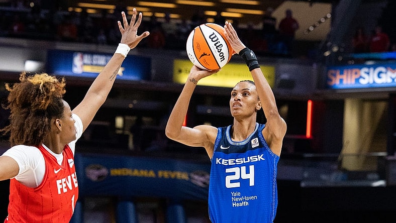 May 19, 2023; Indianapolis, Indiana, USA; Connecticut Sun forward DeWanna Bonner (24)  shoots the ball while Indiana Fever forward Nalyssa Smith (1) defends in the first half at Gainbridge Fieldhouse. Mandatory Credit: Trevor Ruszkowski-USA TODAY Sports