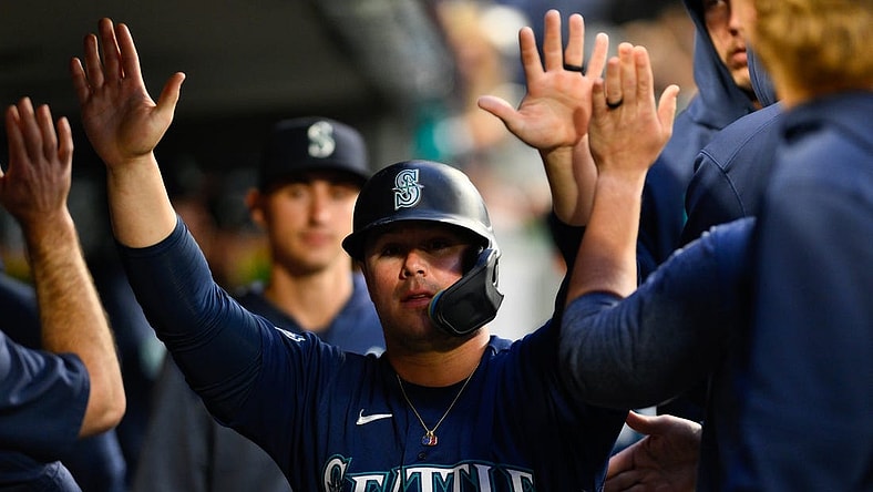 May 22, 2023; Seattle, Washington, USA; Seattle Mariners first baseman Ty France (23) celebrates in the dugout after scoring a run off a single hit by third baseman Eugenio Suarez (28) during the sixth inning against the Oakland Athletics at T-Mobile Park. Mandatory Credit: Steven Bisig-USA TODAY Sports