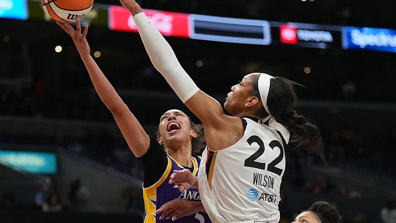 May 25, 2023; Los Angeles, California, USA; LA Sparks guard Kianna Smith (5) shoots the ball against Las Vegas Aces forward A'ja Wilson (22) during the first half at Crypto.com Arena. Mandatory Credit: Kirby Lee-USA TODAY Sports