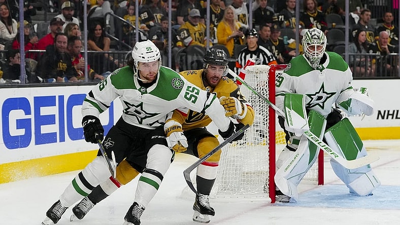 May 27, 2023; Las Vegas, Nevada, USA; Dallas Stars defenseman Thomas Harley (55) keeps the puck away from Vegas Golden Knights right wing Reilly Smith (19) during the second period in game five of the Western Conference Finals of the 2023 Stanley Cup Playoffs at T-Mobile Arena. Mandatory Credit: Stephen R. Sylvanie-USA TODAY Sports