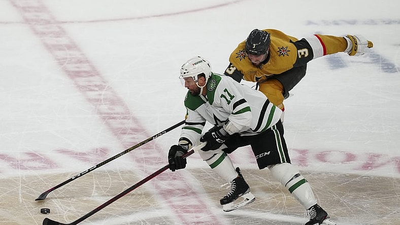 May 27, 2023; Las Vegas, Nevada, USA; Dallas Stars center Luke Glendening (11) skates with the puck past Vegas Golden Knights defenseman Brayden McNabb (3) during the third period in game five of the Western Conference Finals of the 2023 Stanley Cup Playoffs at T-Mobile Arena. Mandatory Credit: Stephen R. Sylvanie-USA TODAY Sports