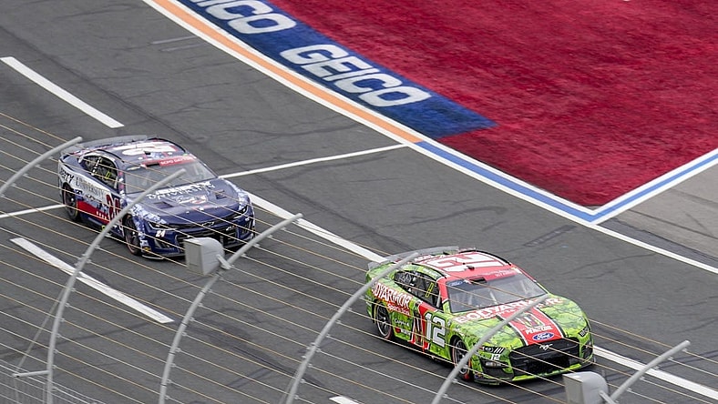 May 29, 2023; Concord, North Carolina, USA; NASCAR Cup Series driver Ryan Blaney (12) takes the lead from driver William Byron (24) during the Coca-Cola 600 at Charlotte Motor Speedway. Mandatory Credit: Jim Dedmon-USA TODAY Sports