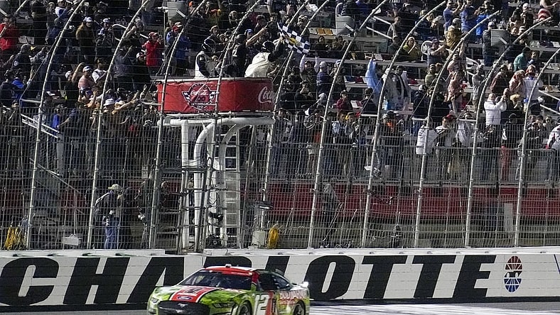 May 29, 2023; Concord, North Carolina, USA; NASCAR Cup Series driver Ryan Blaney (12) takes the checkered flag during the Coca-Cola 600 at Charlotte Motor Speedway. Mandatory Credit: Jim Dedmon-USA TODAY Sports