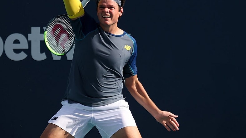 Mar 30, 2021; Miami, Florida, USA; Milos Raonic of Canada hits a forehand against Hubert Hurkacz of Poland (not pictured) in the fourth round in the Miami Open at Hard Rock Stadium. Mandatory Credit: Geoff Burke-USA TODAY Sports