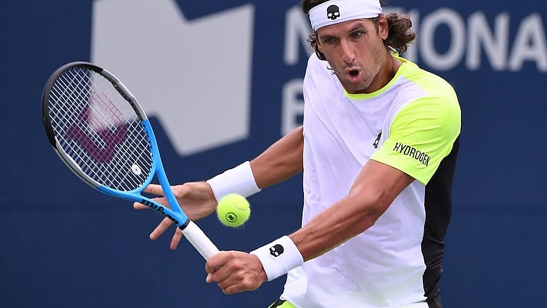 Aug 8, 2021; Toronto, Ontario, Canada;  Feliciano Lopez of Spain plays a shot against Yoshihito Nishioka of Japan during second round qualifying for the National Bank Open. Mandatory Credit: Dan Hamilton-USA TODAY Sports