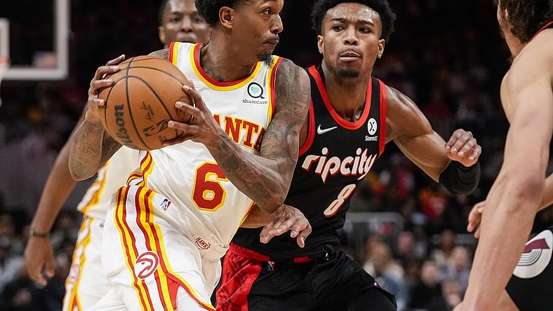 Mar 14, 2022; Atlanta, Georgia, USA; Atlanta Hawks guard Lou Williams (6) drives the ball past Portland Trail Blazers guard Brandon Williams (8) during the second half at State Farm Arena. Mandatory Credit: Dale Zanine-USA TODAY Sports